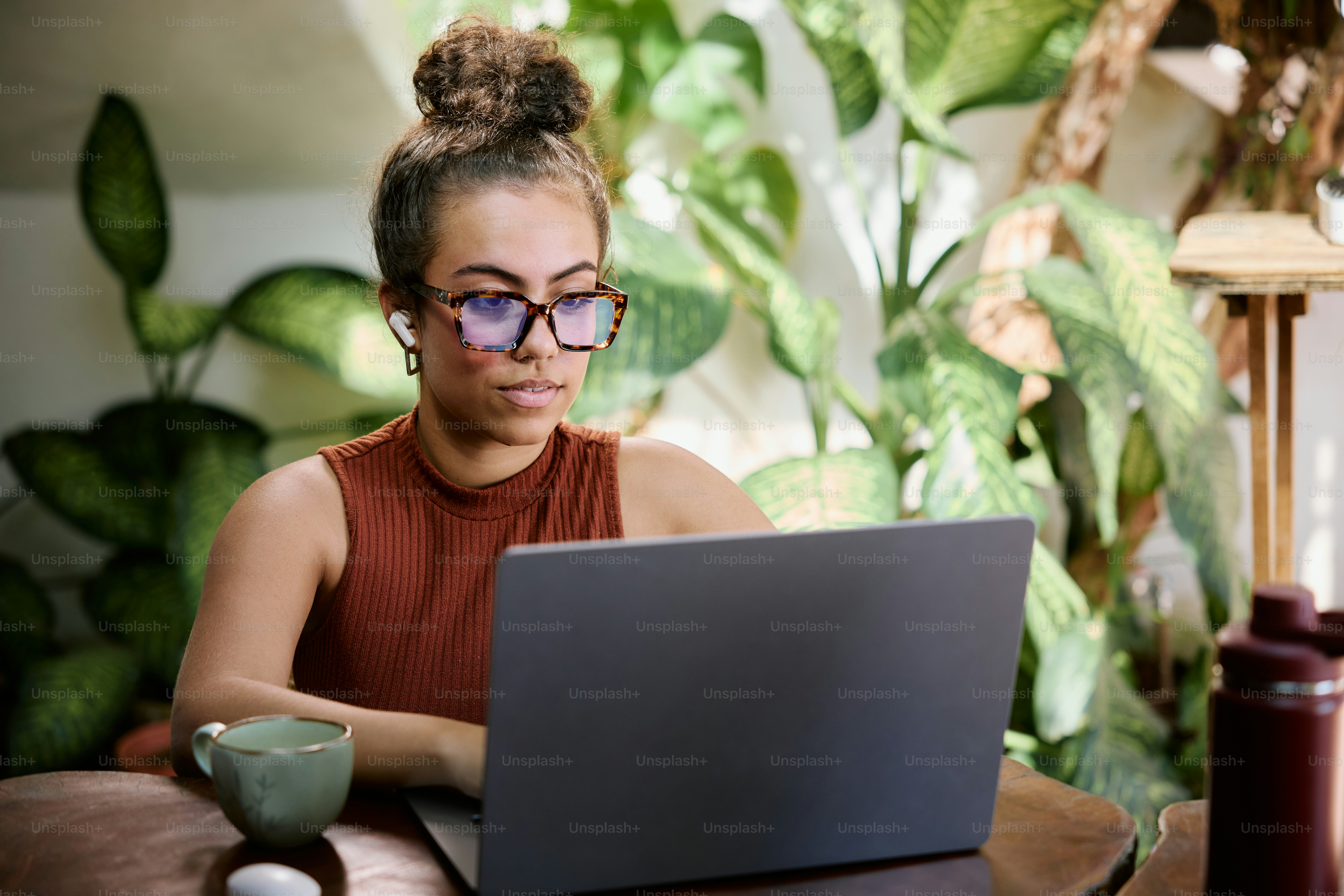 A woman sitting in front of a laptop computer